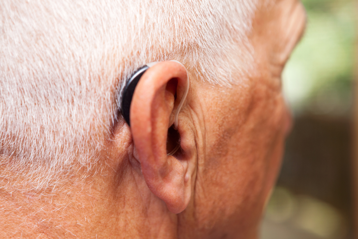 Older man wearing hearing aid